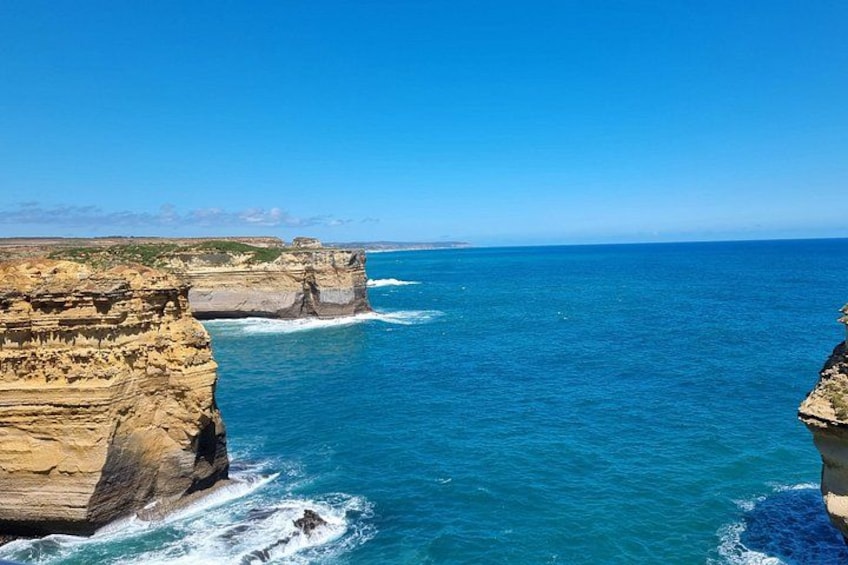 A coastal cliff with a clear blue sea. 3