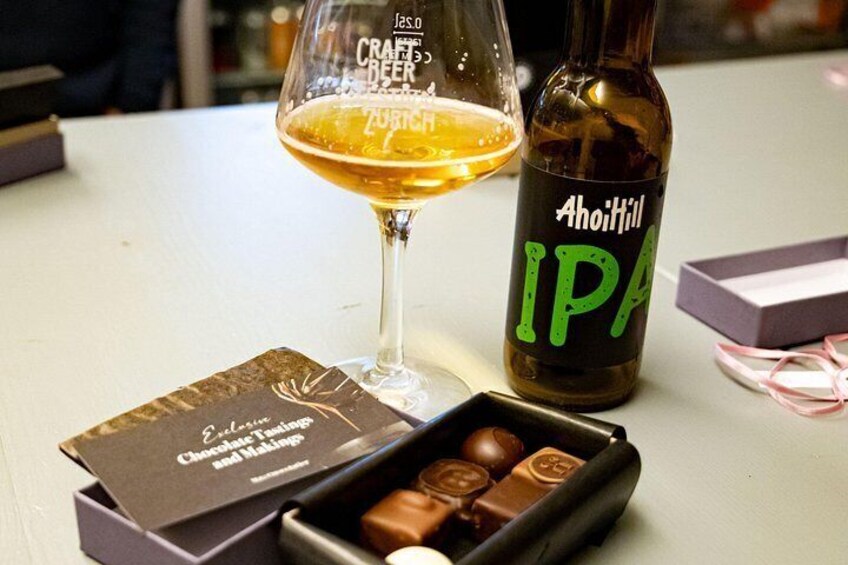 A glass of beer, a bottle of Ahoittill IPA, and a box of chocolates. 1