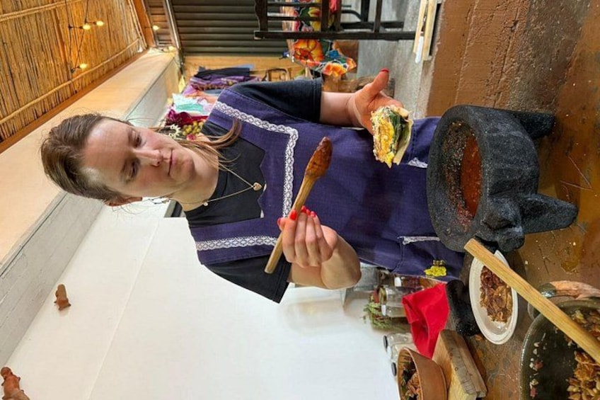 A person cooking with a large pot and a wooden spoon. 4
