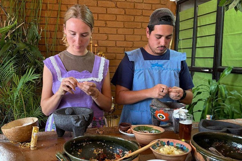 Two people preparing food with various bowls and utensils. 5