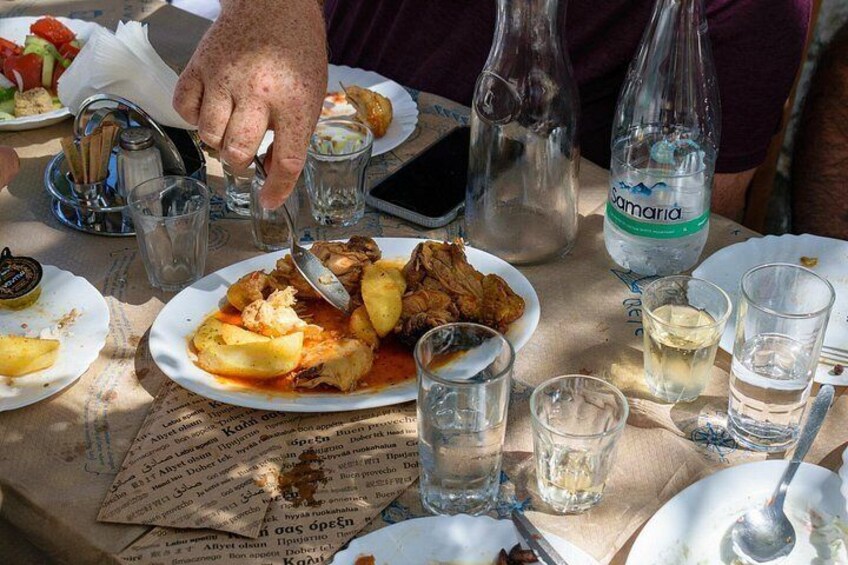 Et bord med tallerkener med mad, glas og en vandflaske. 4