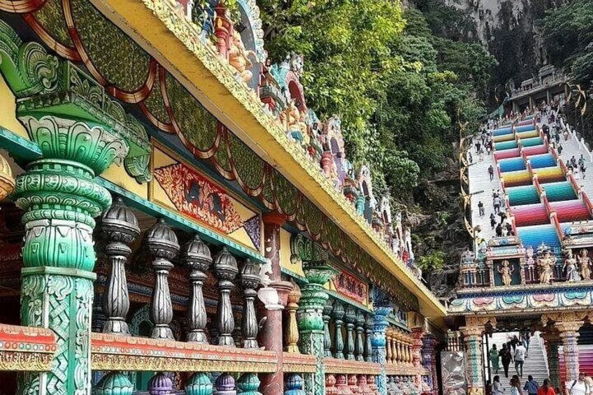 A temple with colorful carvings and steps leading up to it. 3