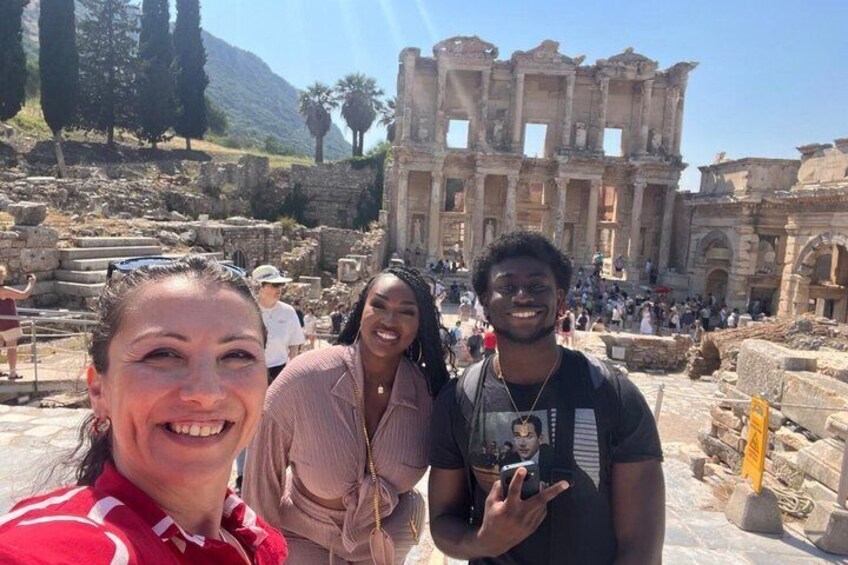 A historical site with ancient ruins and a large, intact building in the background. 5
