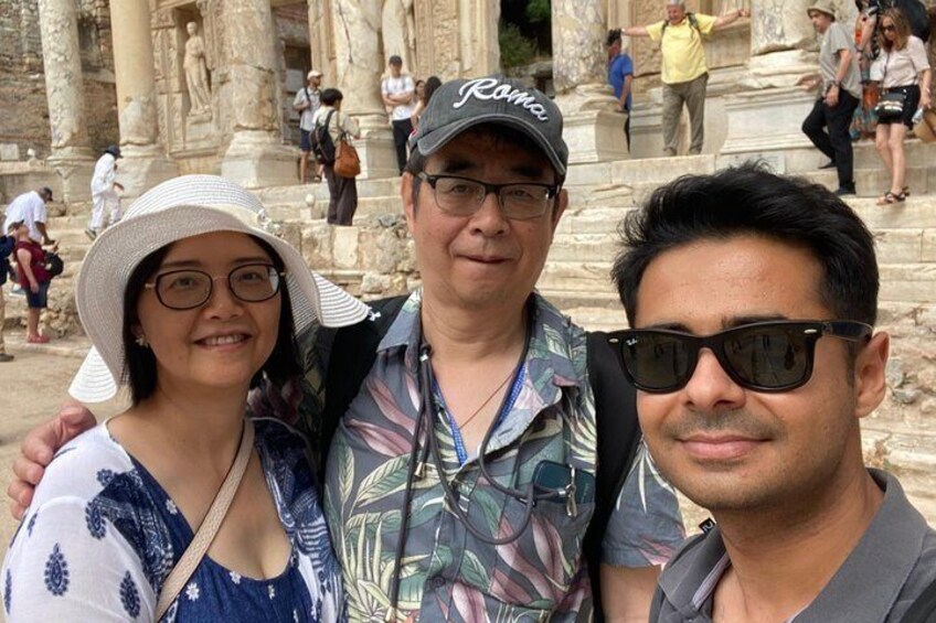 A group of people in front of ancient ruins with columns and statues. 4