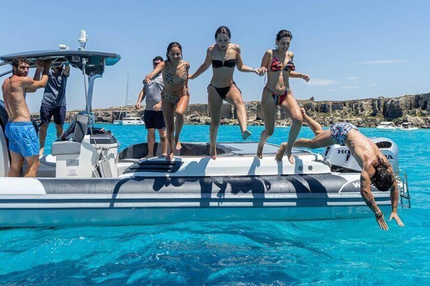 People jumping off a boat into a pool. 4