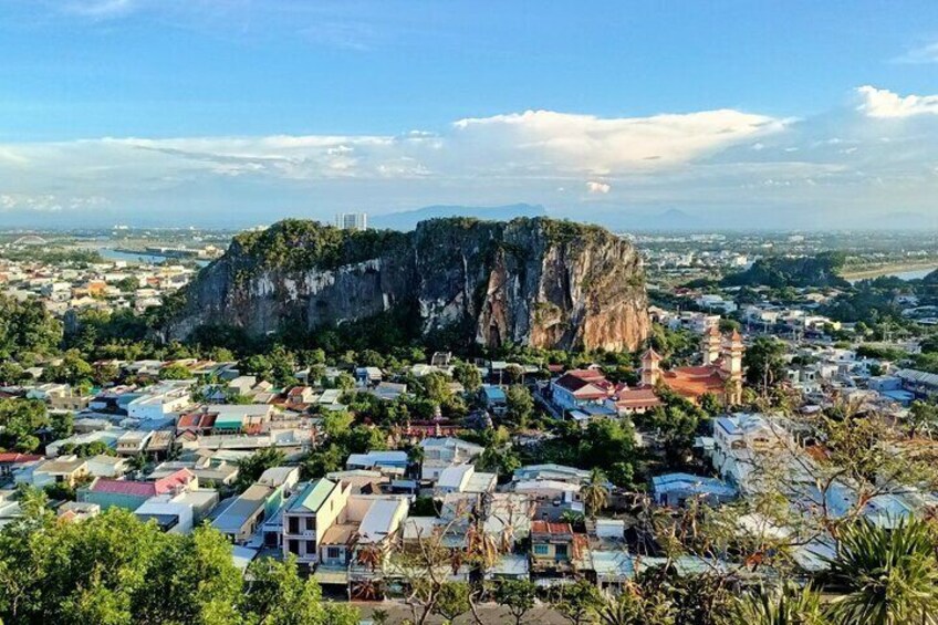 A coastal town with a prominent cliff and a temple. 2