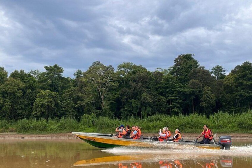 A boat with people wearing life jackets on a river. 2