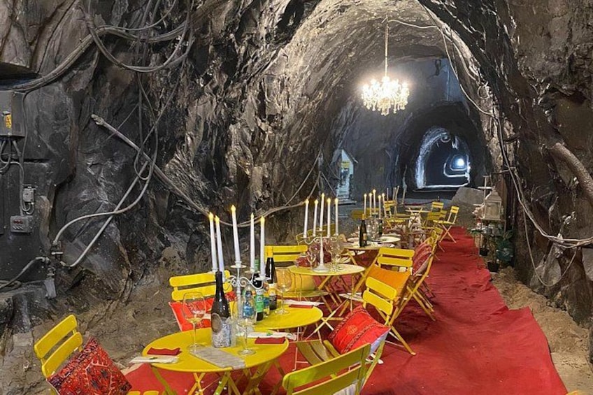 Un espace repas aménagé avec des tables et des chaises, dans un décor évoquant une grotte. 2