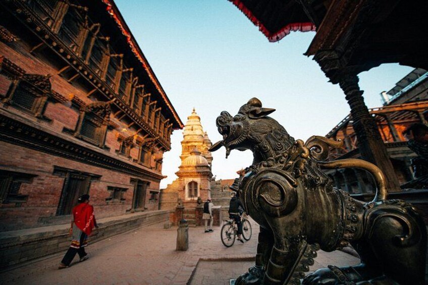 A traditional building with intricate architecture, a statue of a horse, and a distant pagoda. 5