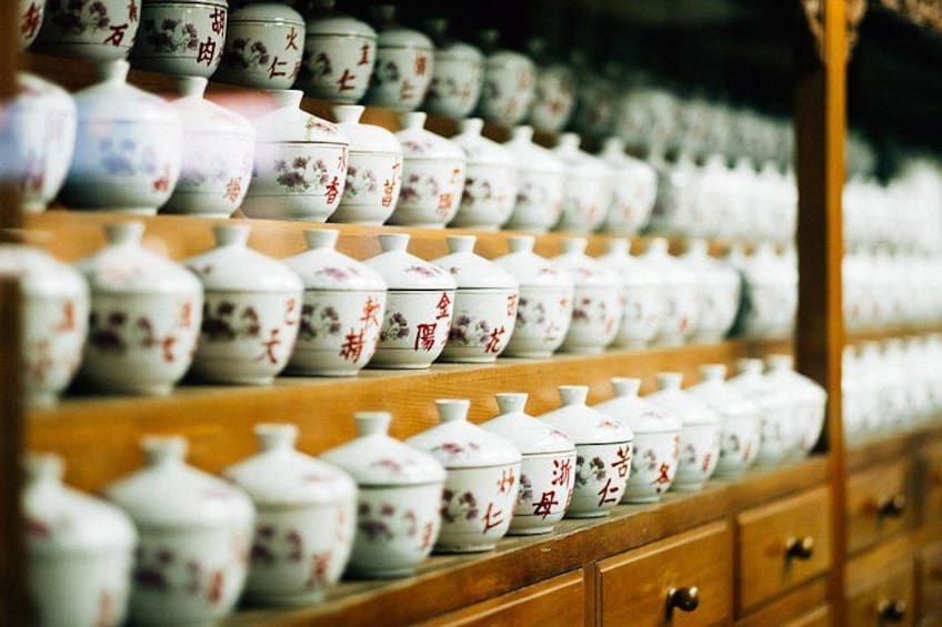 A display of ceramic bowls with floral patterns and Chinese characters. 2