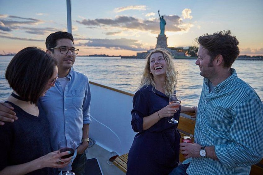A group of people on a boat with the Statue of Liberty in the background. 4