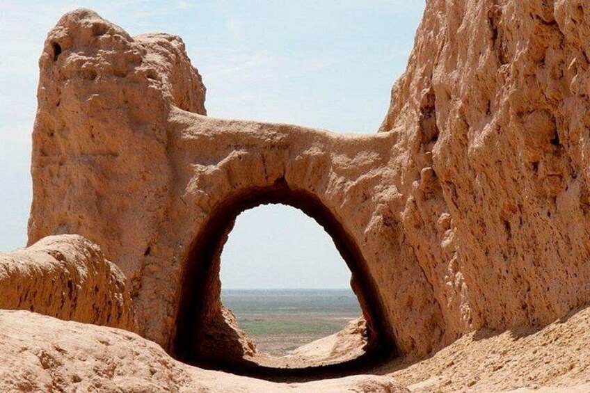 A natural rock arch formation with a clear view of the landscape beyond. 3