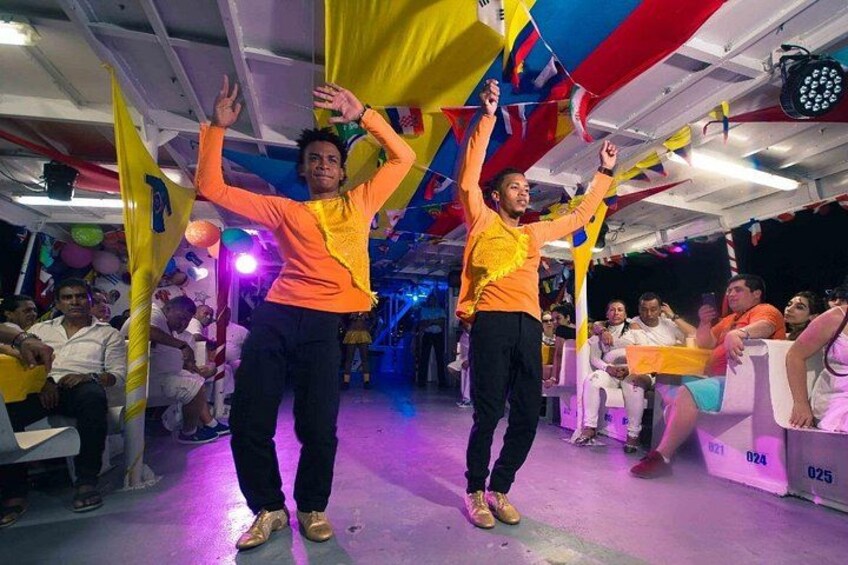 Two people dancing in a decorated indoor space with spectators. 5