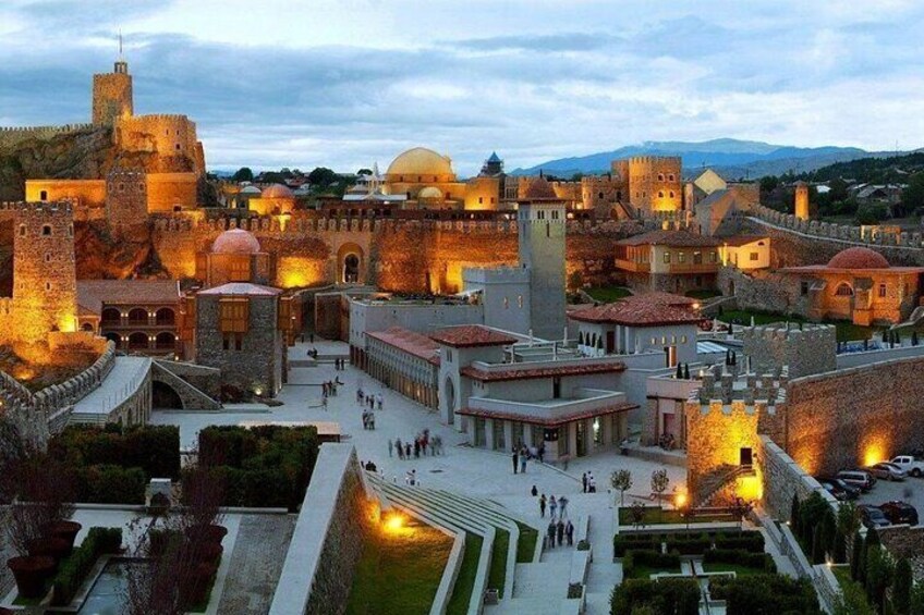 A historic walled city with ancient architecture, including towers and domed buildings. 2
