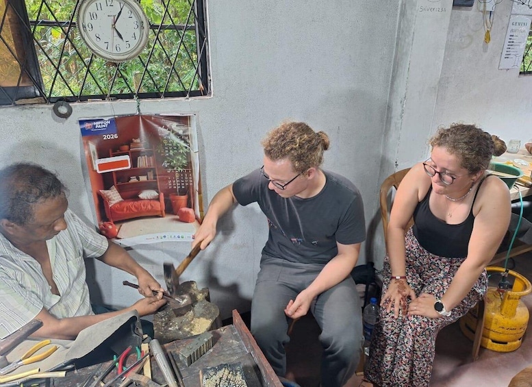Three people in a room with a clock, a calendar, and a gas cylinder. 5