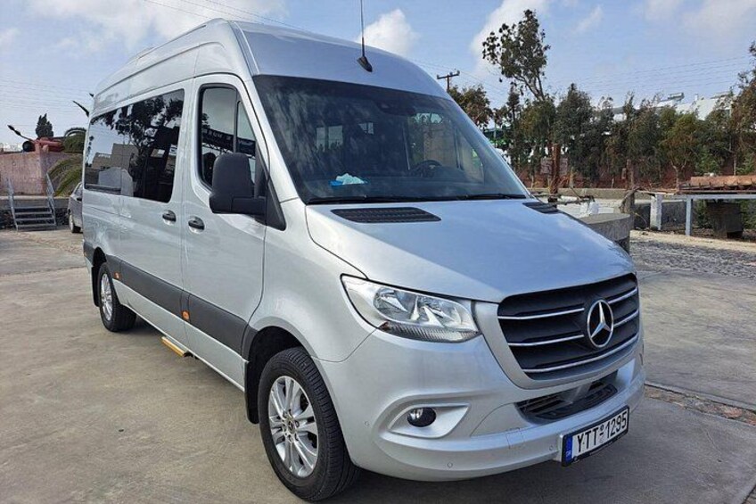 A silver Mercedes van parked on a concrete surface with a license plate visible. 5