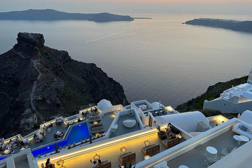 A coastal resort with a pool, lounge area, and ocean views. 2