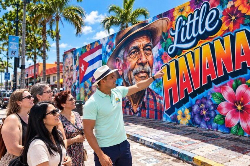 Een muurschildering met de tekst 'Little Havana' en een man die ernaar wijst. 1