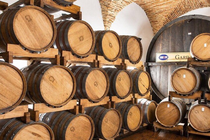 Wooden wine barrels stacked in a warehouse. 4
