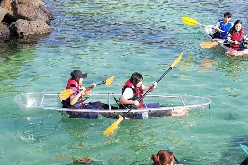 Two people in a kayak on clear water. 3