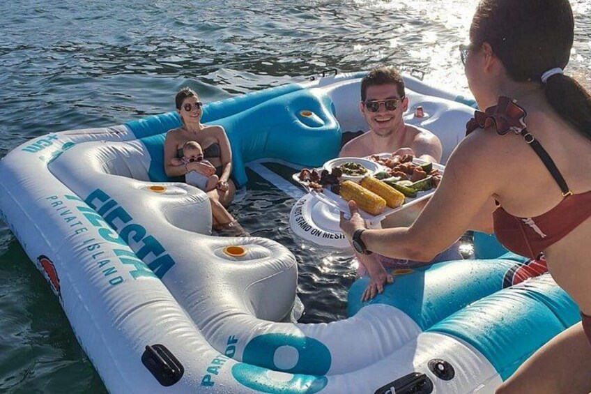 A group of people on a blue and white inflatable raft on water. 5