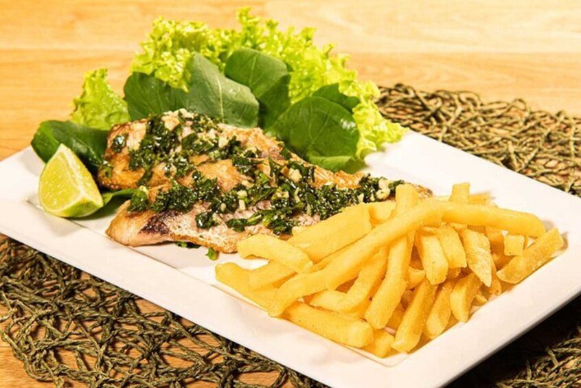 A plate with grilled chicken, fries, and greens. 5
