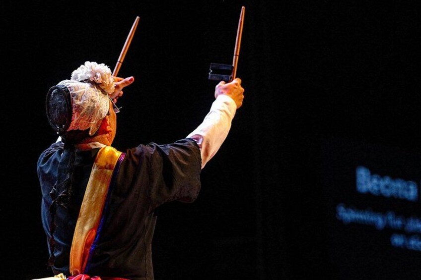 A person conducting an orchestra with a baton. 4