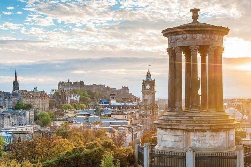 A cityscape with a prominent neoclassical monument, historic buildings, and a clock tower. 5