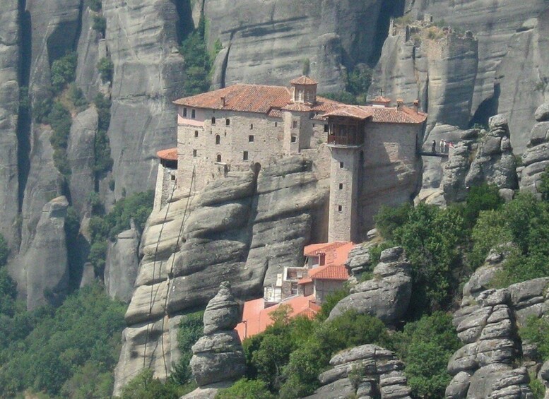 A monastery perched atop a rock formation. 3