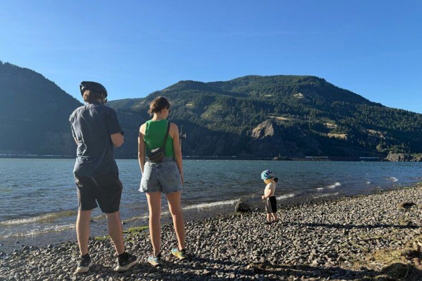 A rocky shoreline with a lake and mountains in the background. 4