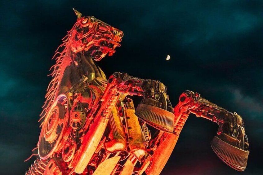 A mechanical horse sculpture with a moon in the background. 1
