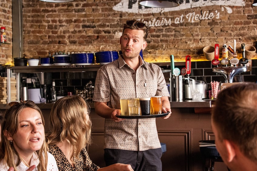 A bartender serving drinks at a bar with a brick wall background. 5