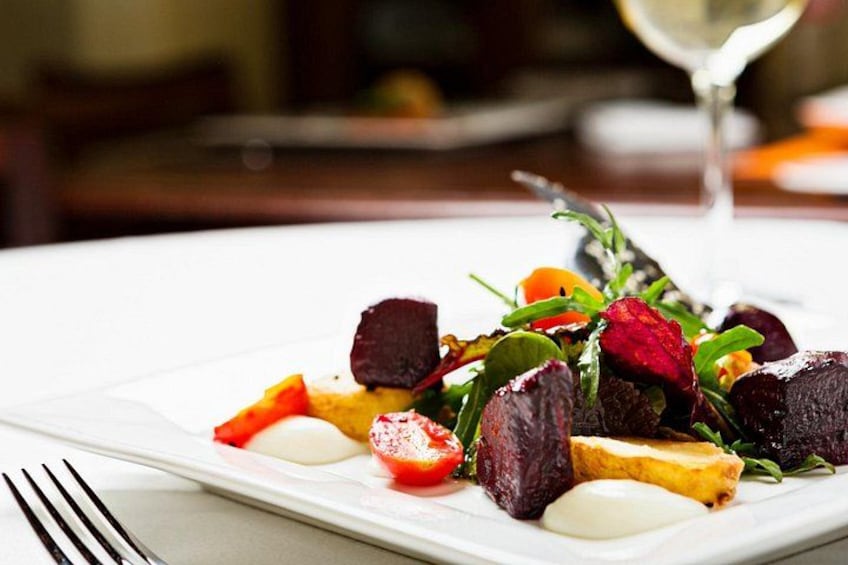 A plate of food with a glass of white wine. 3