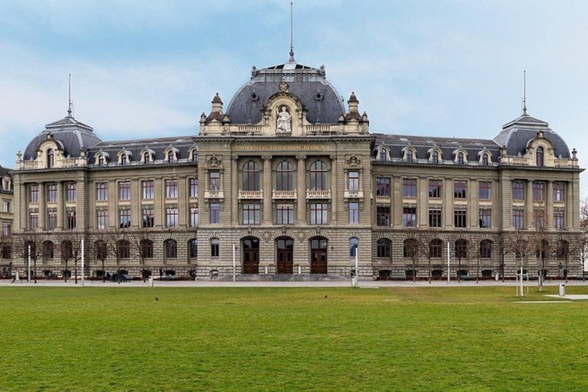 A large, historic building with a central dome and multiple smaller domes, surrounded by a well-maintained lawn. 2
