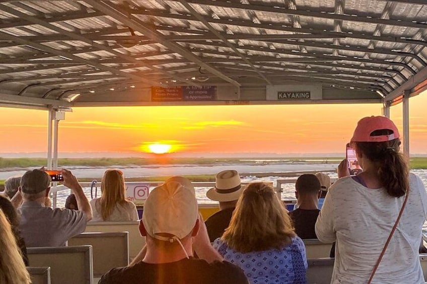 People on a boat watching a sunset. 1