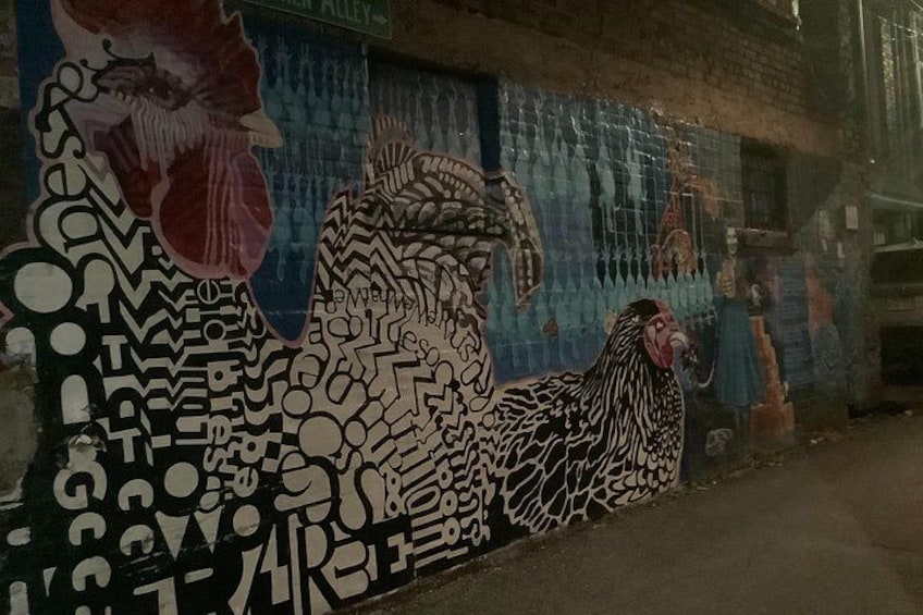 A mural with abstract patterns and a rooster. 1