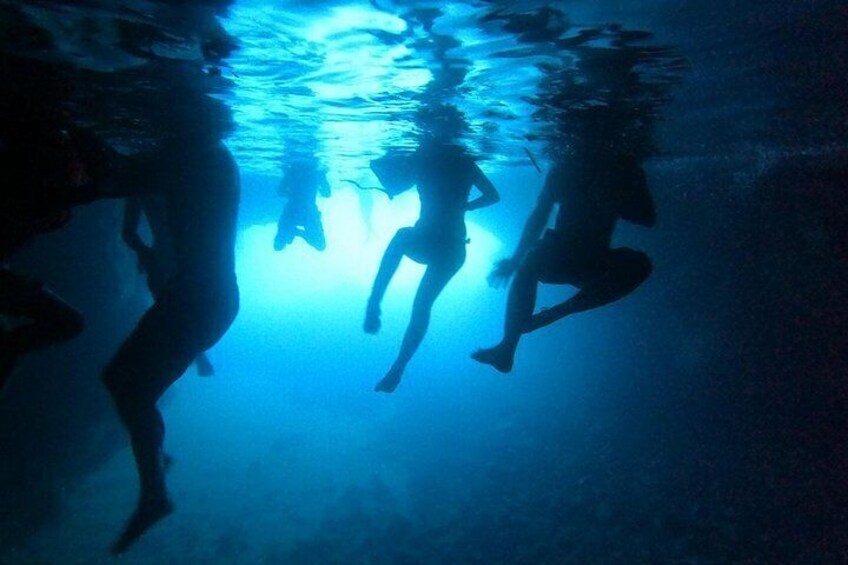 People swimming underwater. 3