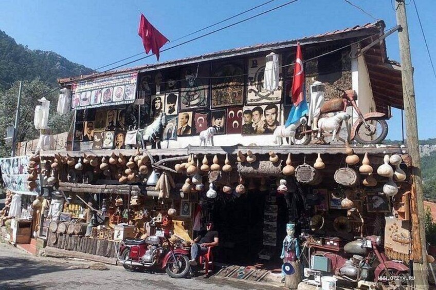 A shop with various items on display, including pottery, a motorcycle, and a bicycle. 4