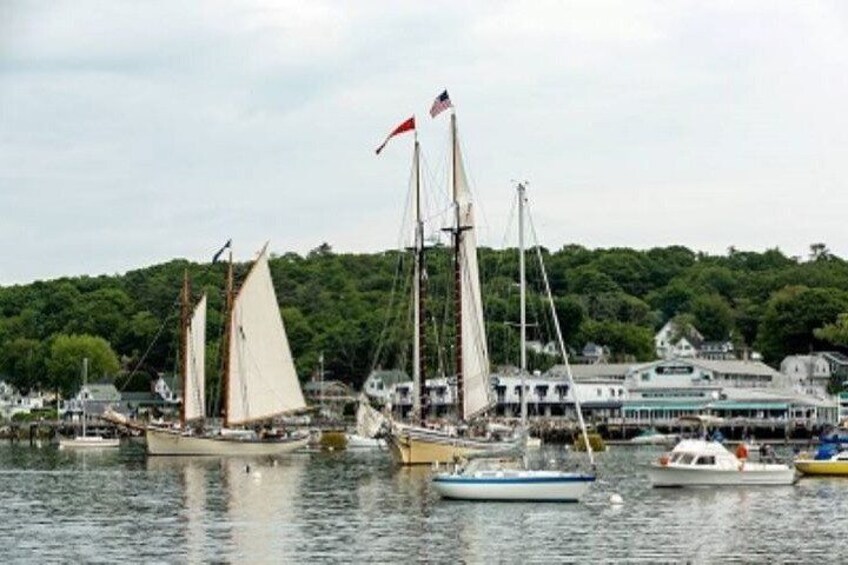 A harbor with sailboats and a waterfront building. 2