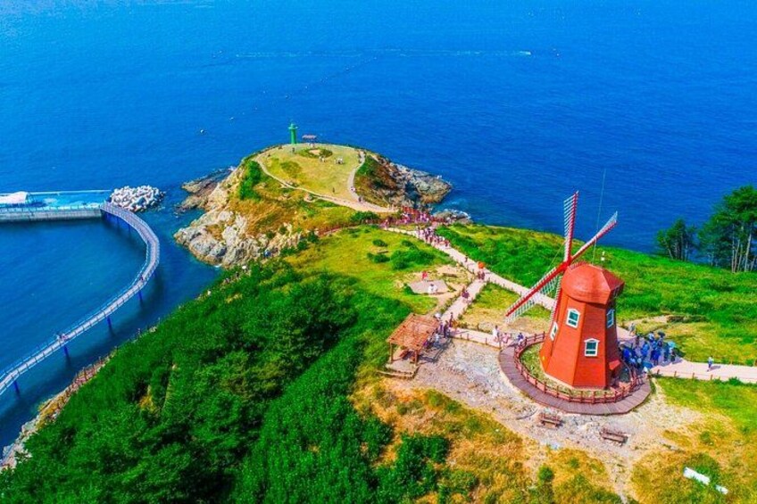 A windmill, a lighthouse, and a coastal road. 3
