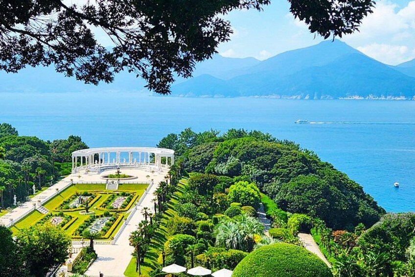 A landscaped garden with a central fountain, surrounded by manicured lawns and pathways. 3