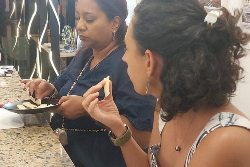 Two people eating, one holding a plate with food. 5