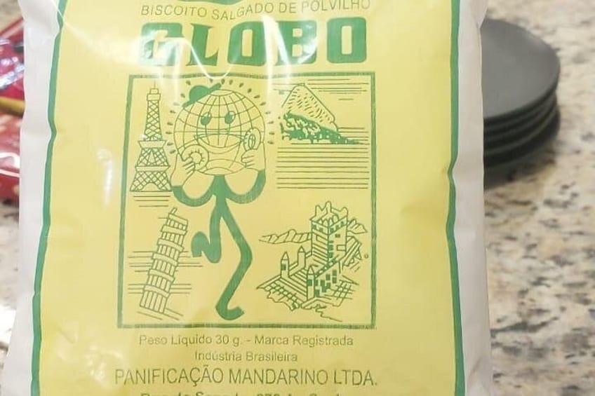 A bag of biscuits with a green and yellow label featuring landmarks and a globe. 2