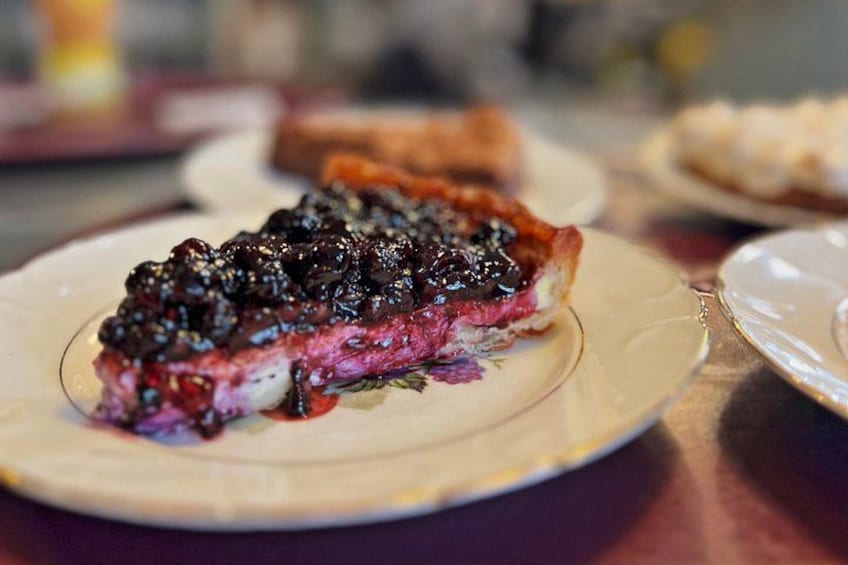 A slice of pie with a berry topping on a plate. 2