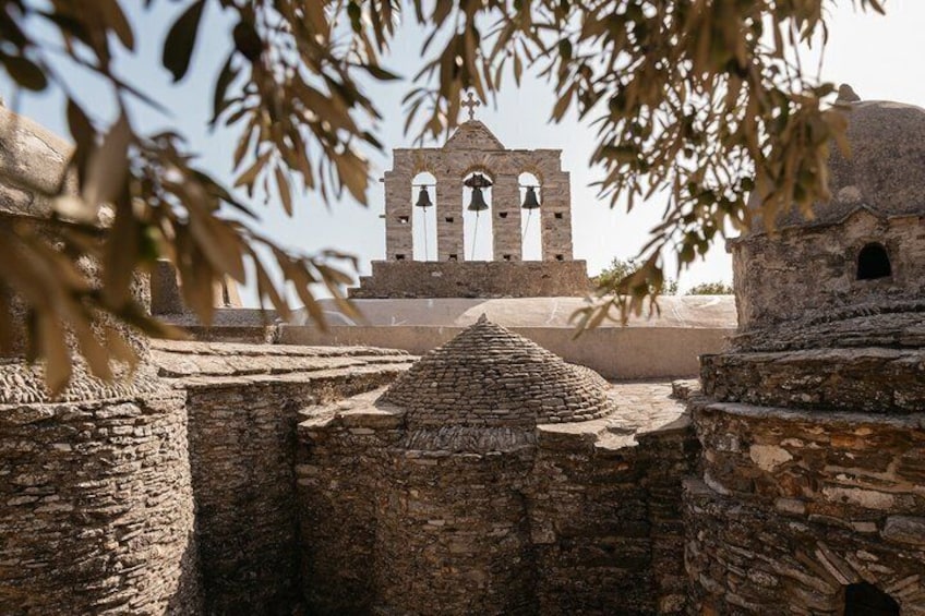 Ancient stone ruins with a bell tower in the background. 5