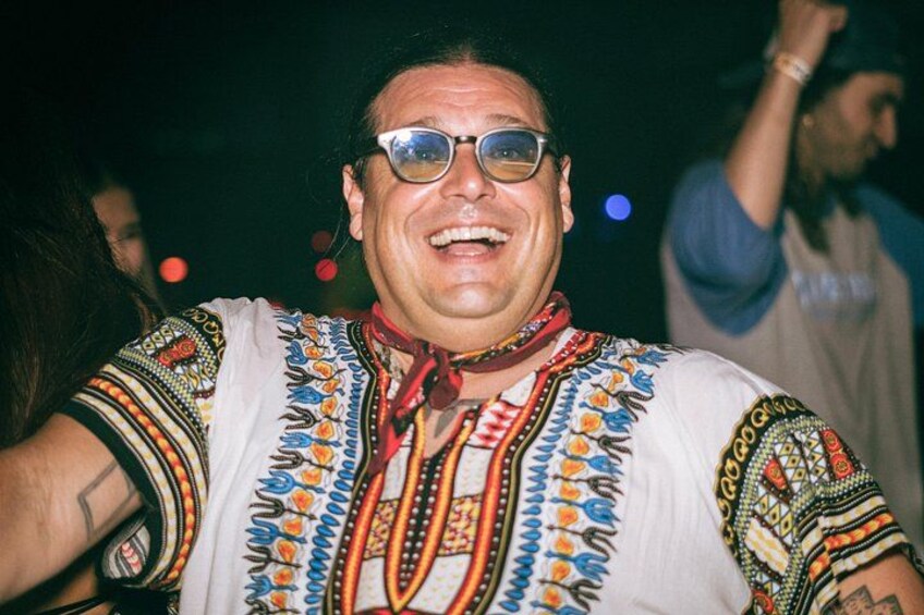 A person wearing a patterned shirt with embroidery. 4