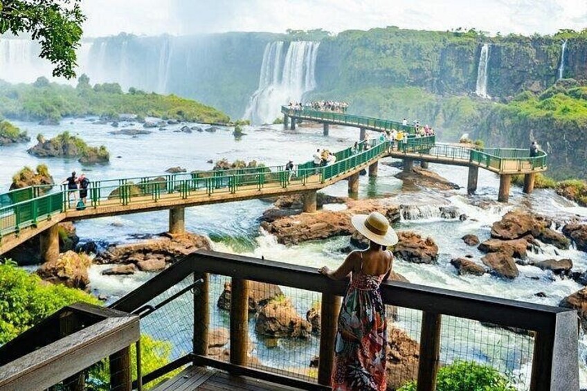 A waterfall, a bridge, and a person wearing a hat. 3
