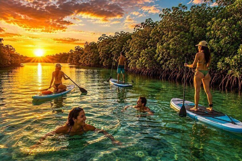 People paddleboarding on a calm river at sunset. 2