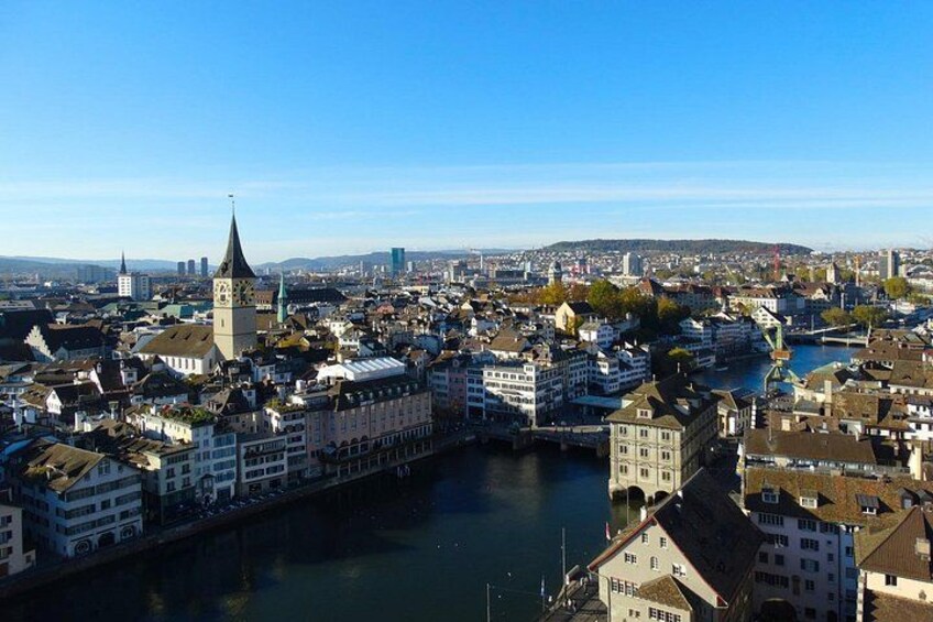A river flowing through a city with historic buildings and a prominent tower. 3