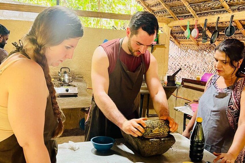A person grinding spices in a stone mortar. 2